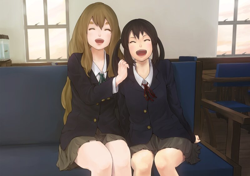Two girls laughing in school uniforms