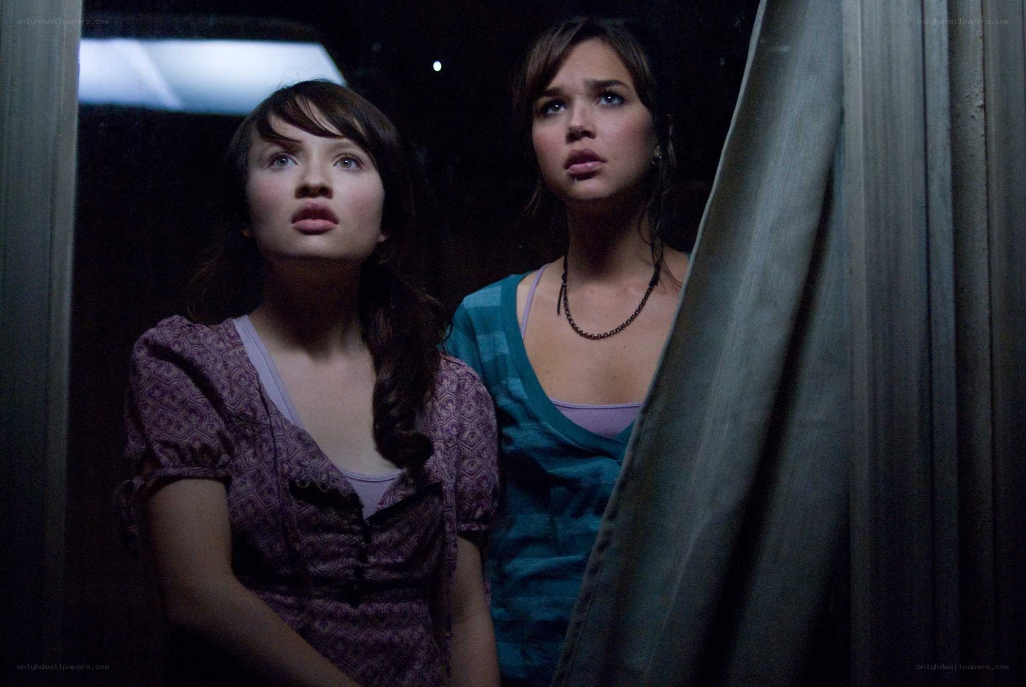 two girls looking up in fear