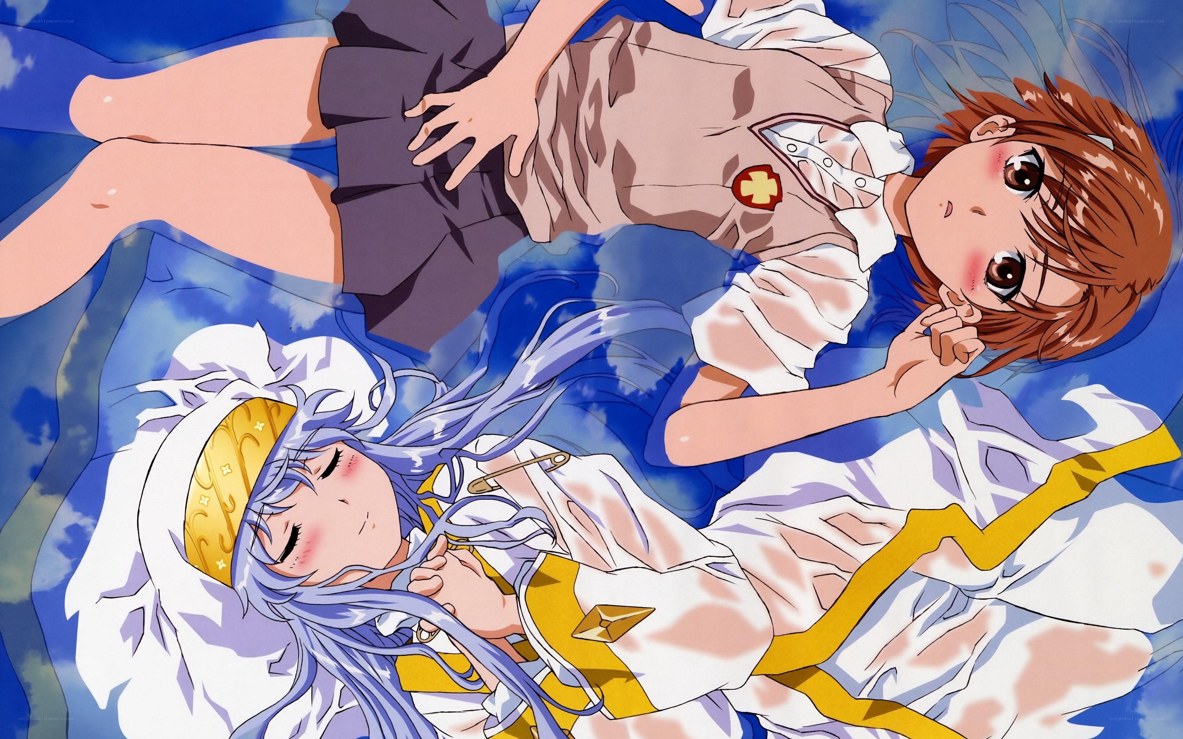 Two girls lying on a blanket