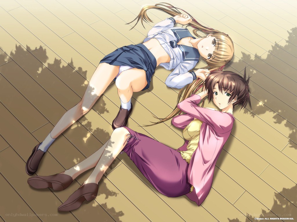 Two girls lying on a deck