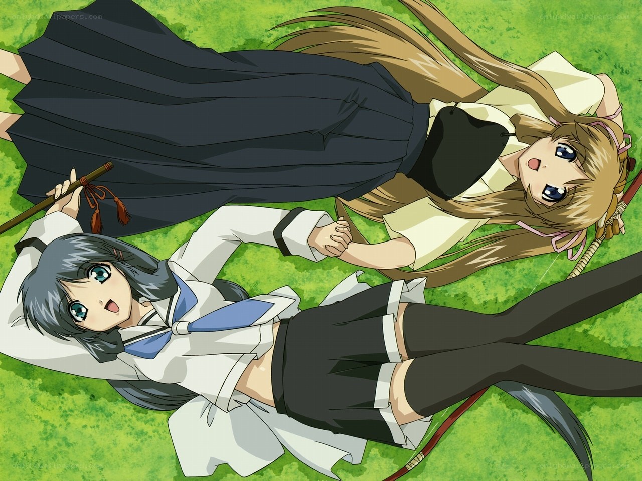Two girls lying on grass