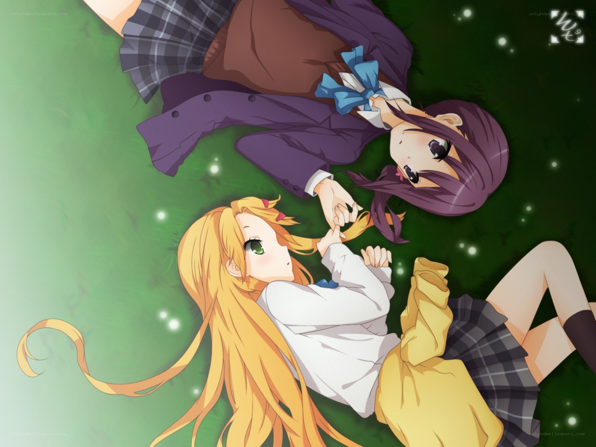Two girls lying on grass