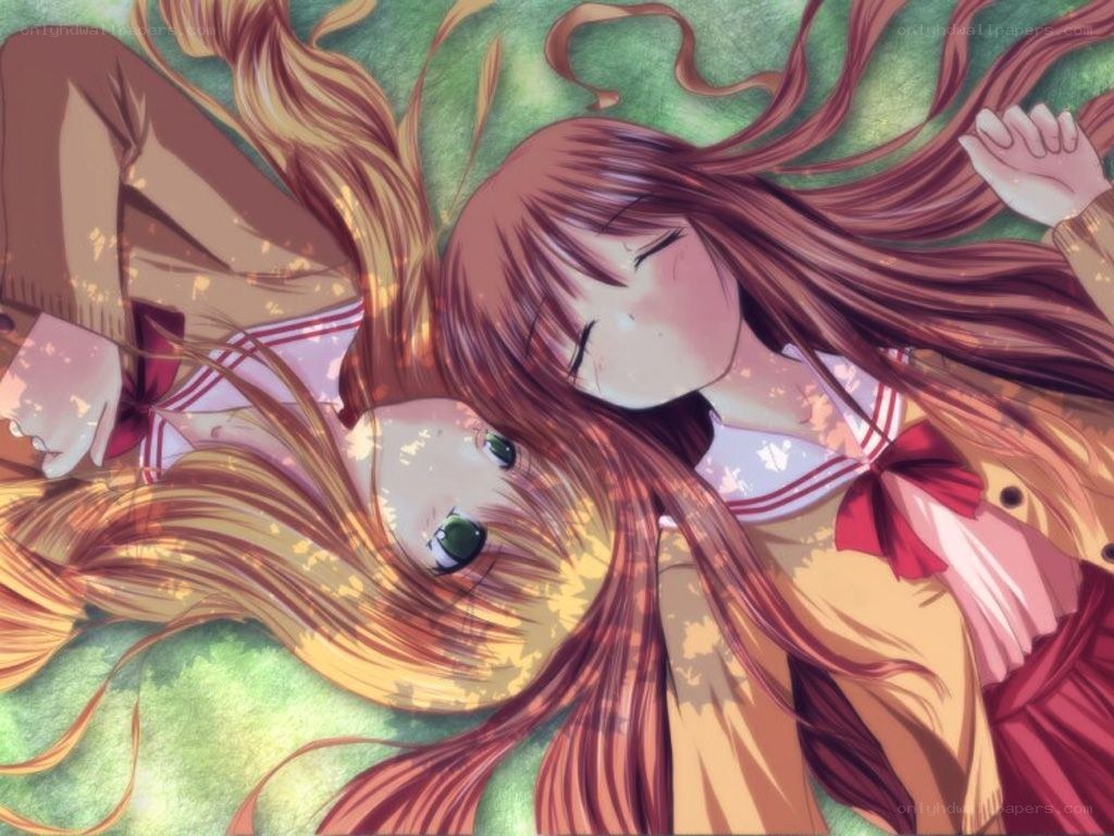 Two girls lying on grass
