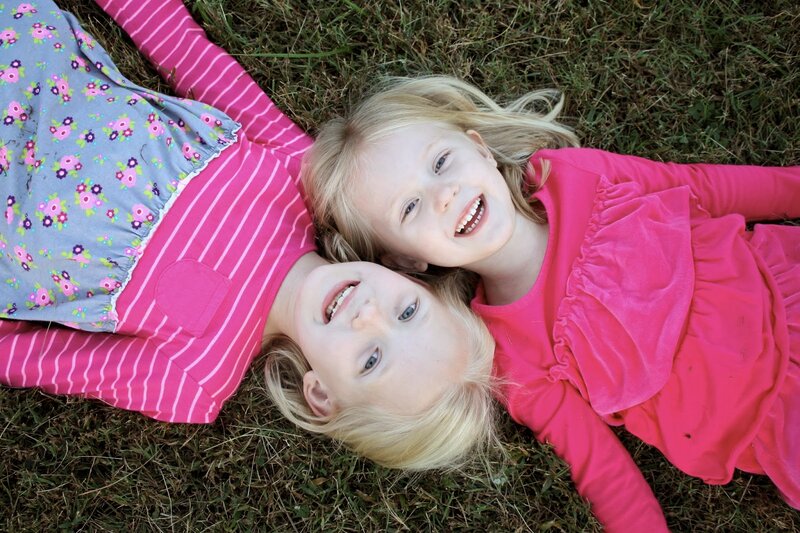 Two Girls Lying on Grass — Pink