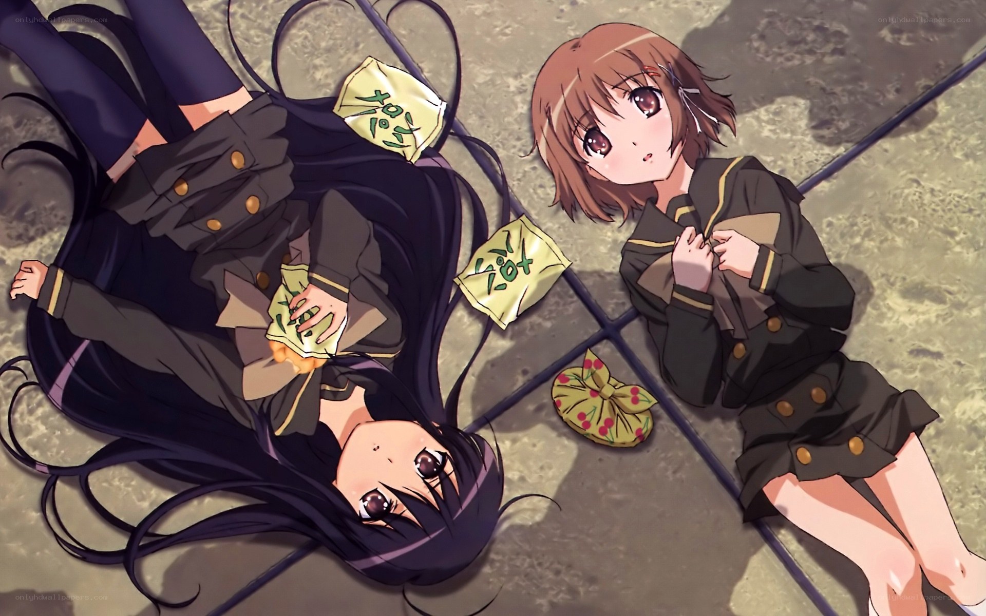 Two girls lying on the ground