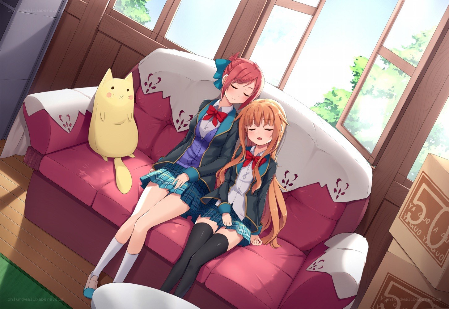 Two girls napping on a couch
