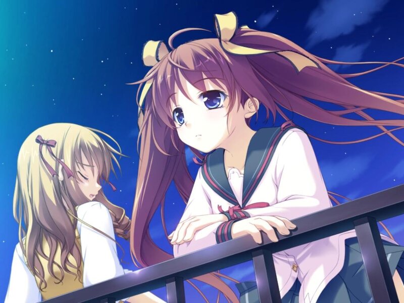 two girls on a balcony at night