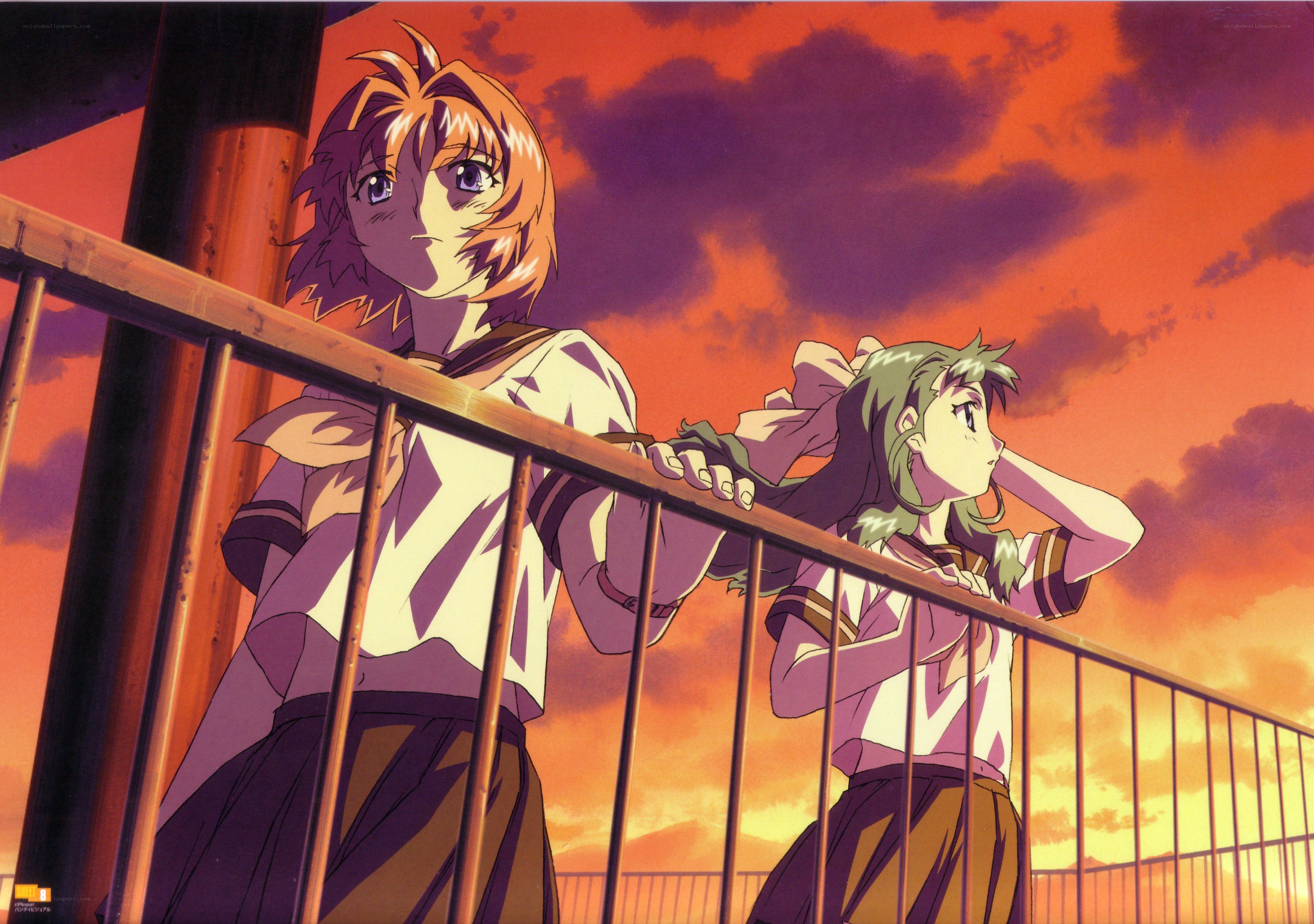 Two girls on a balcony at sunset