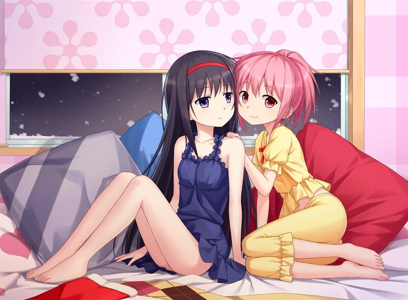 Two girls on a bed at night