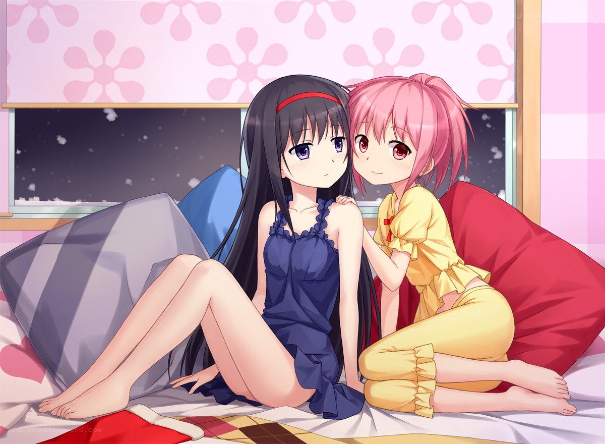 Two girls on a bed at night