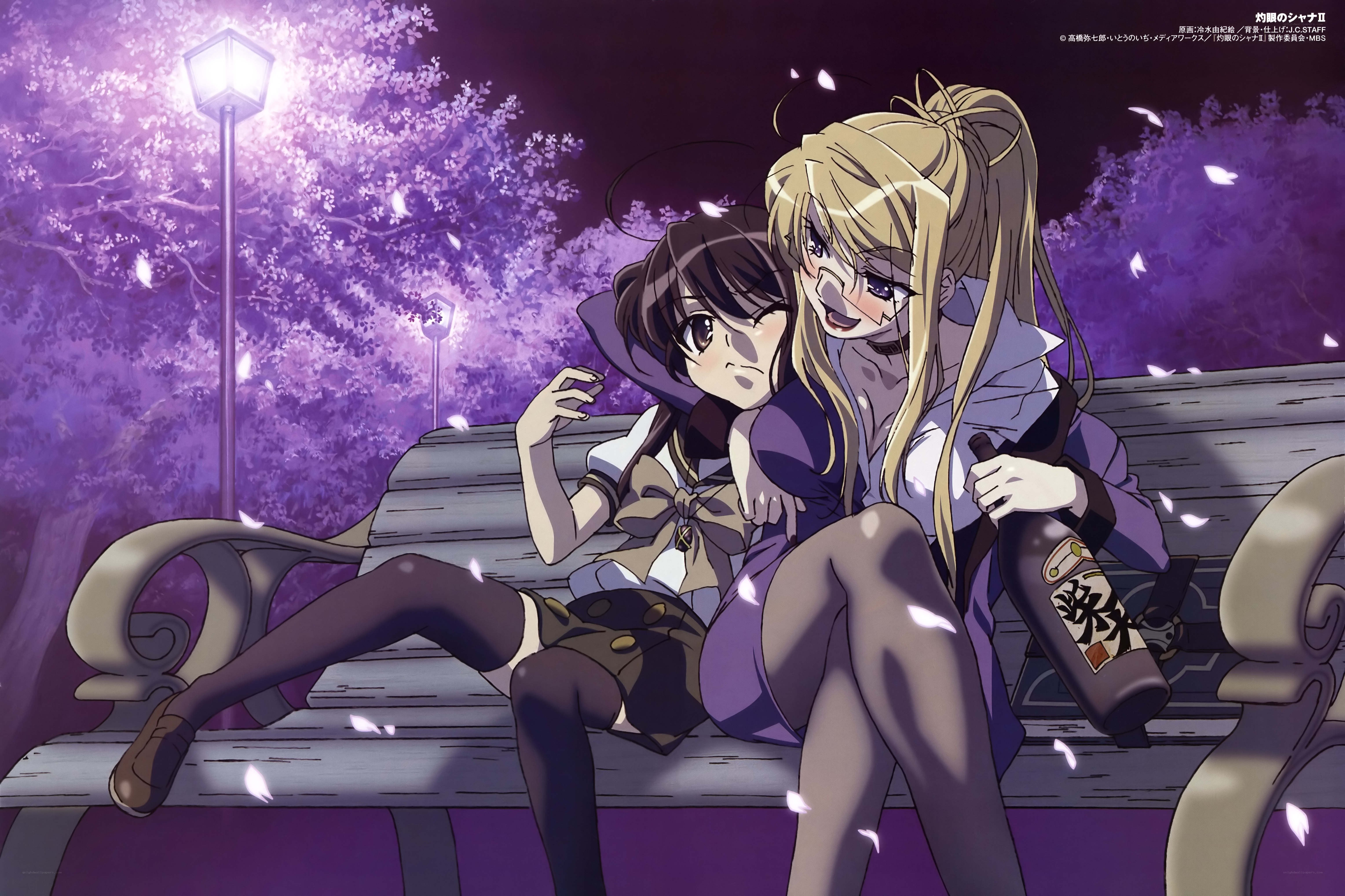 Two girls on a bench at night