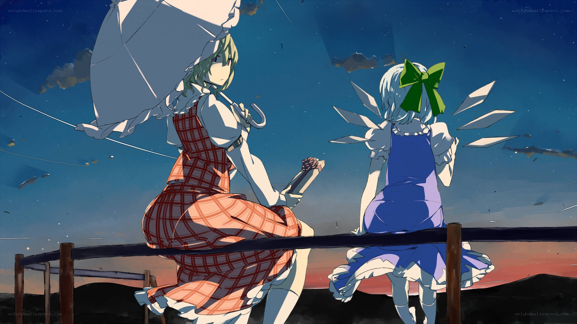 Two girls on a bridge at dusk