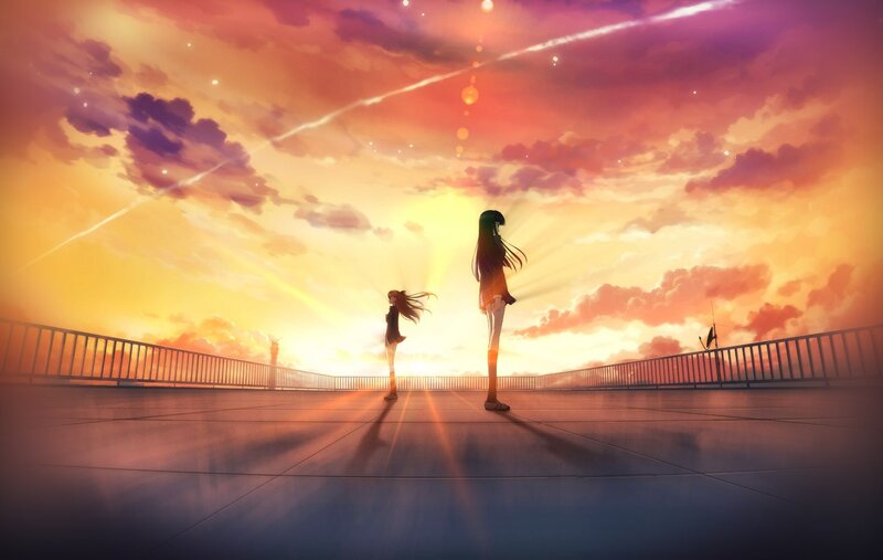 Two girls on a bridge at sunset