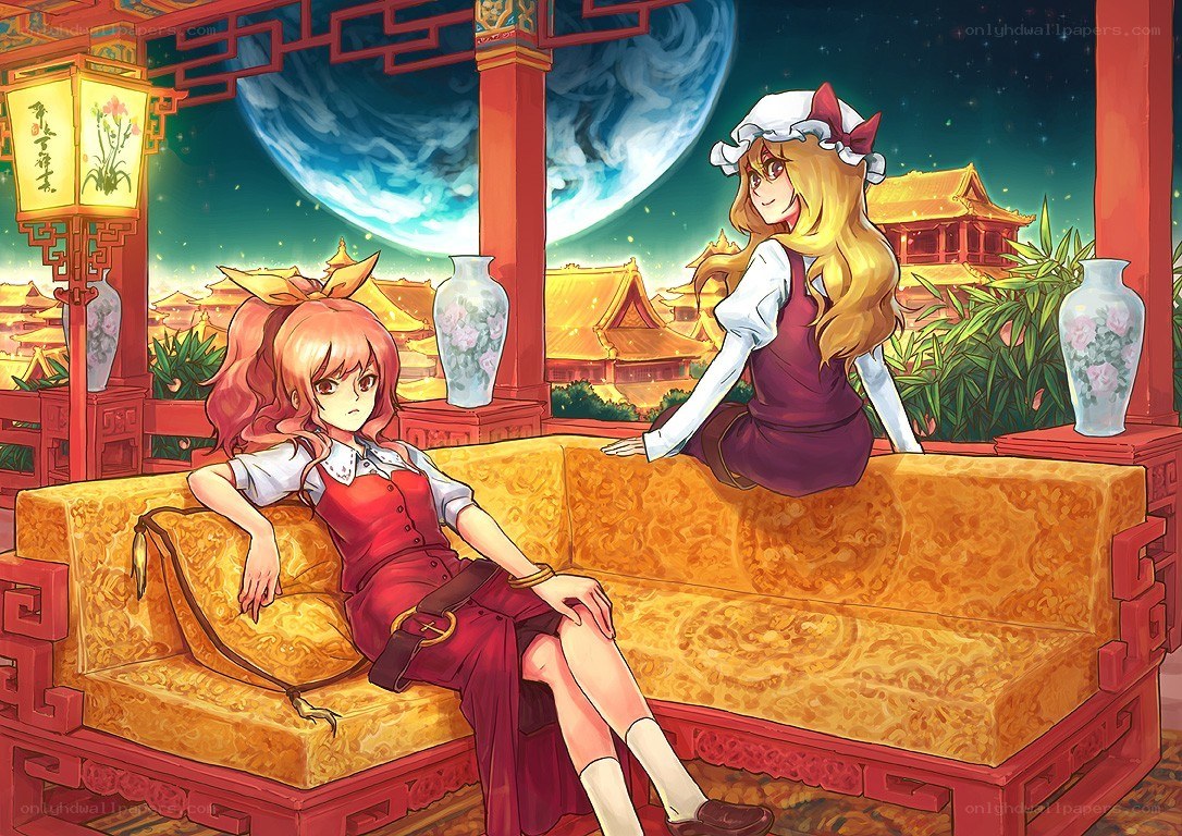 Two girls on a couch at night