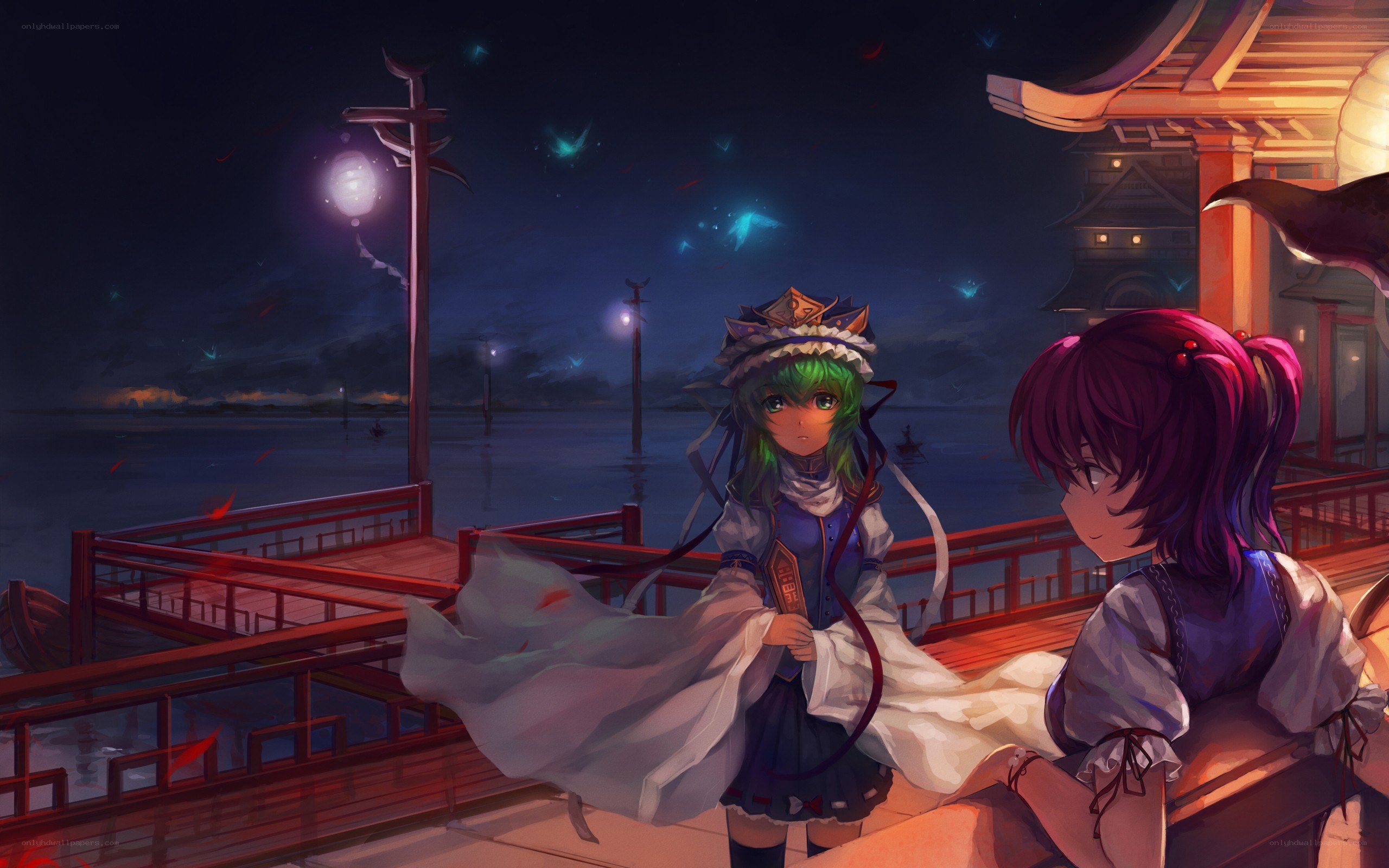 Two girls on a dock at night