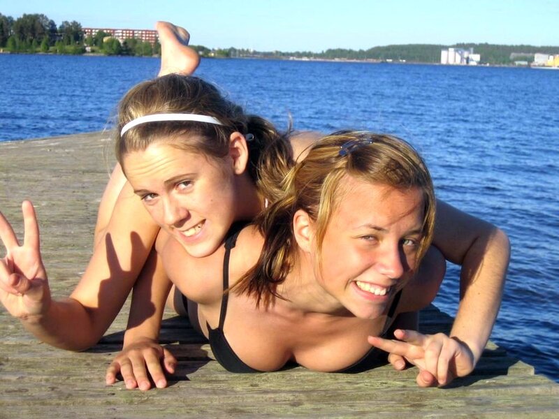 Two girls on a dock by the water