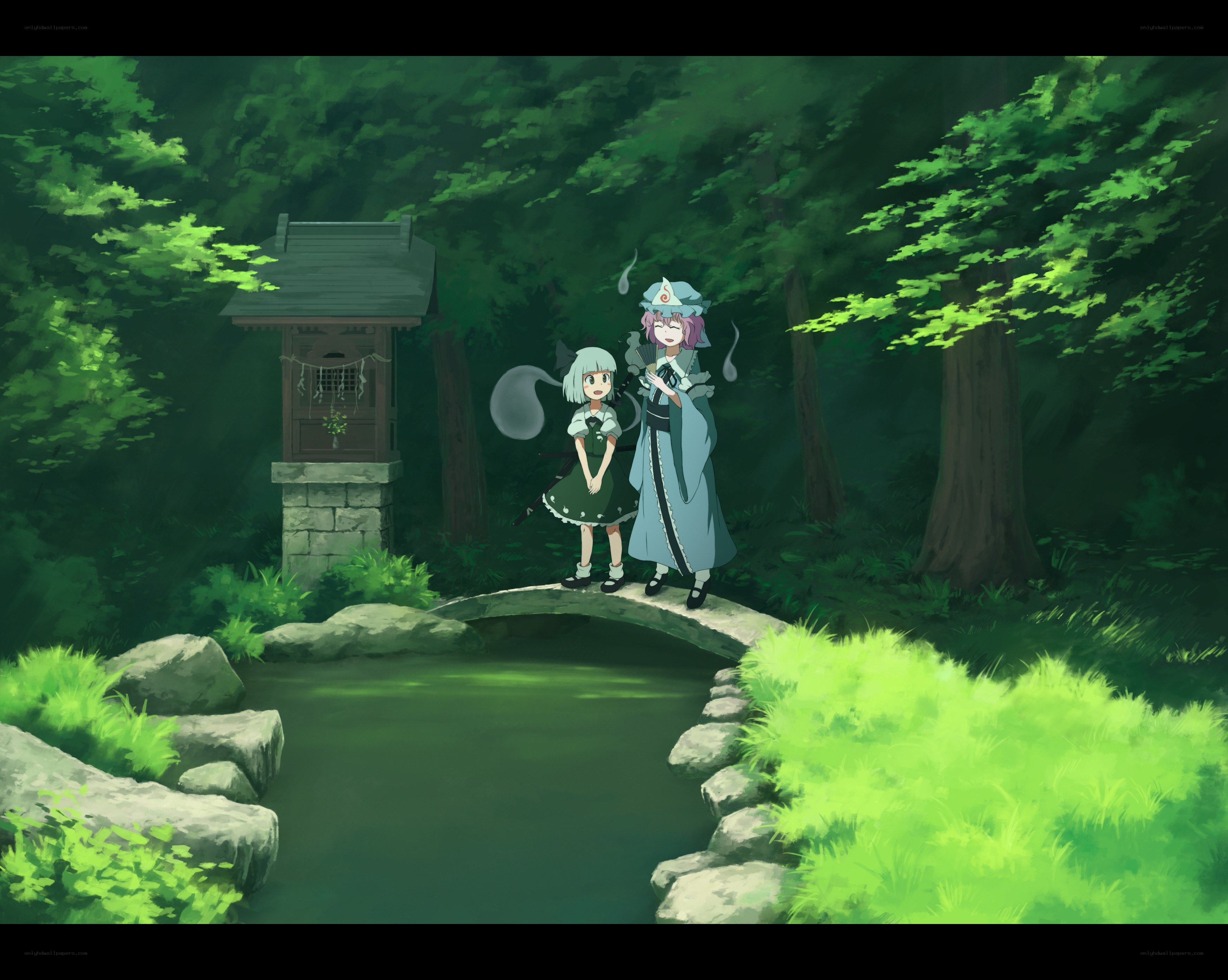 Two girls on a forest bridge