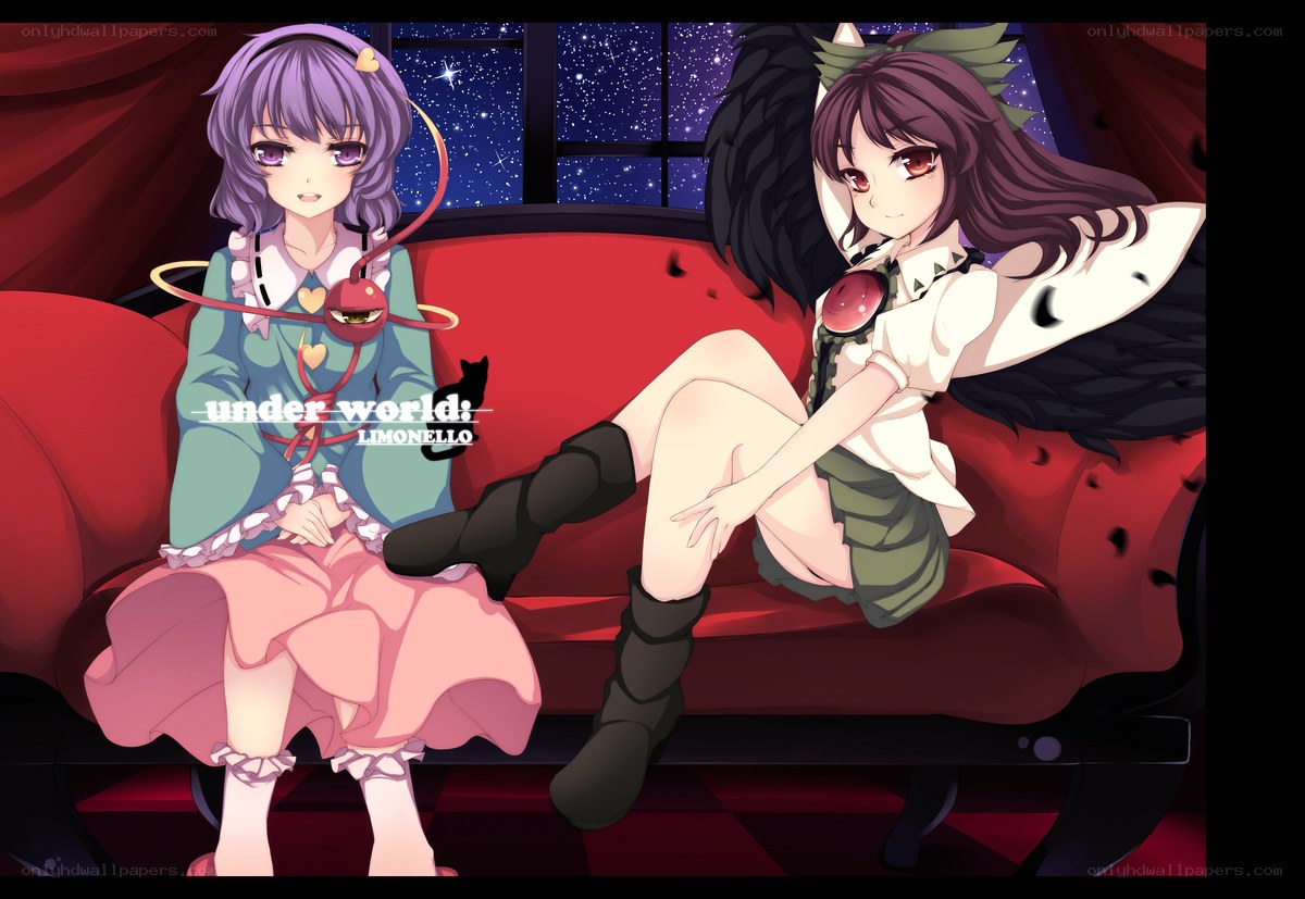 Two girls on a red couch