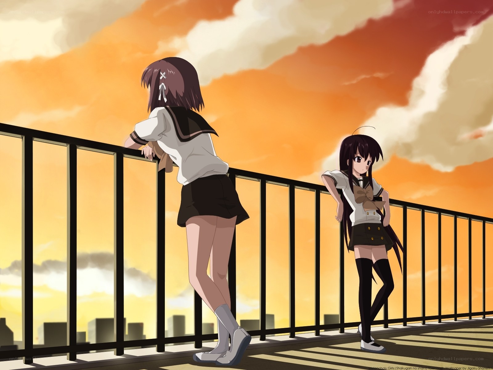 Two girls on a rooftop at sunset