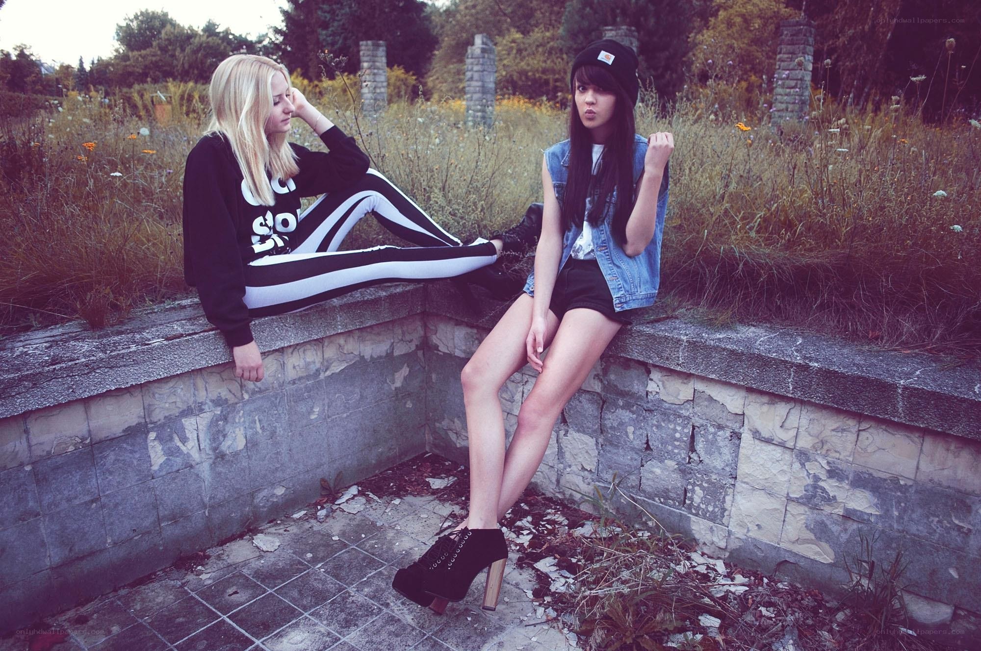 Two girls on a wall