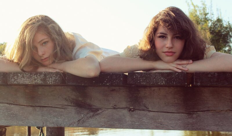 two girls on a wooden dock