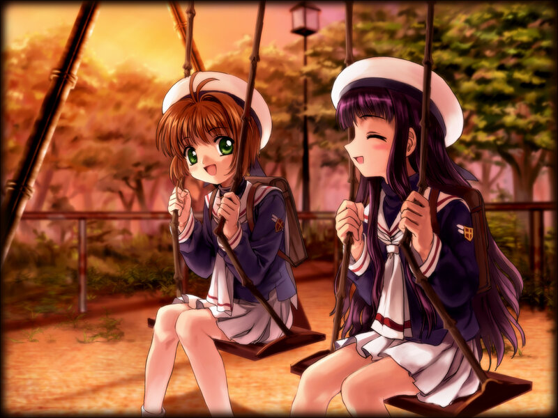 Two girls on swings at sunset
