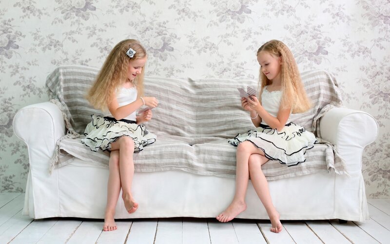 Two Girls Playing Cards — White