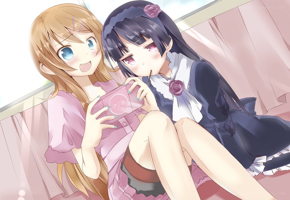 Two girls playing on a handheld console