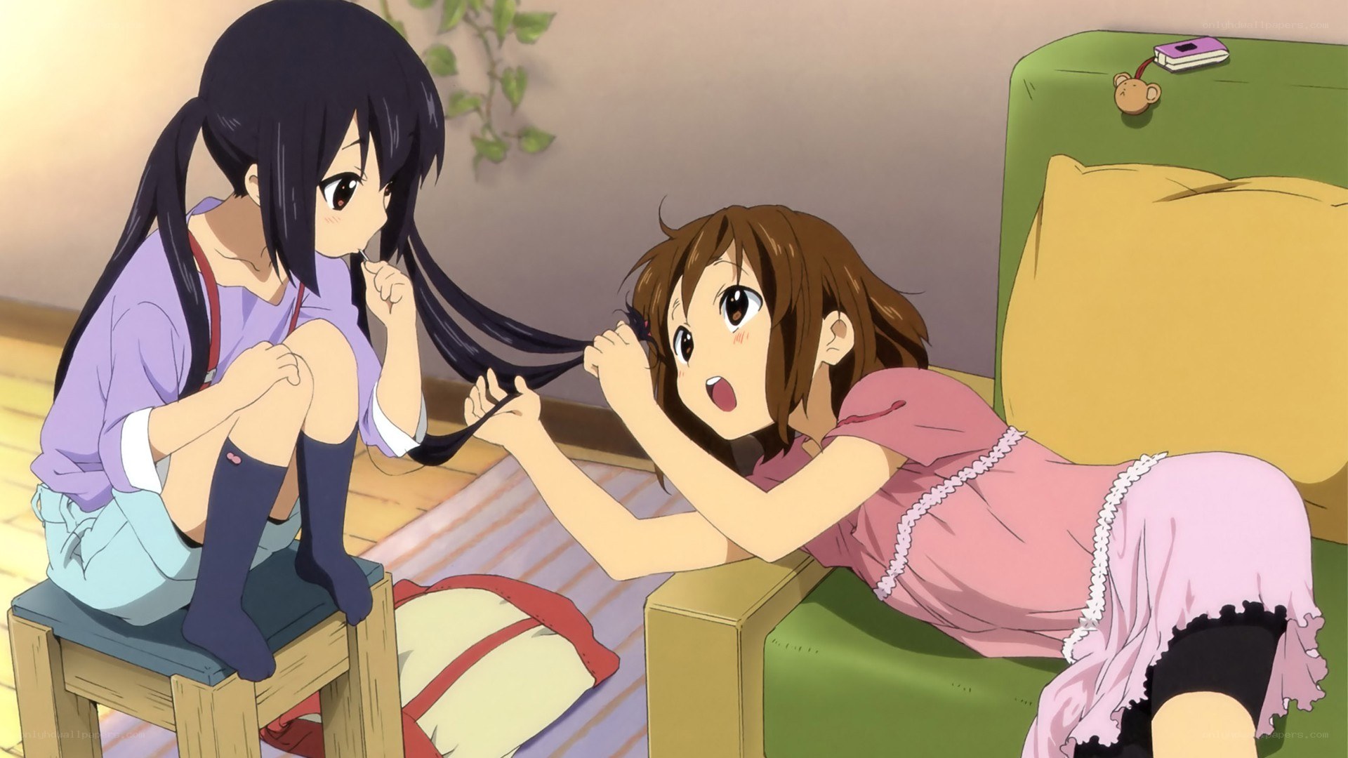 Two girls playing with hair