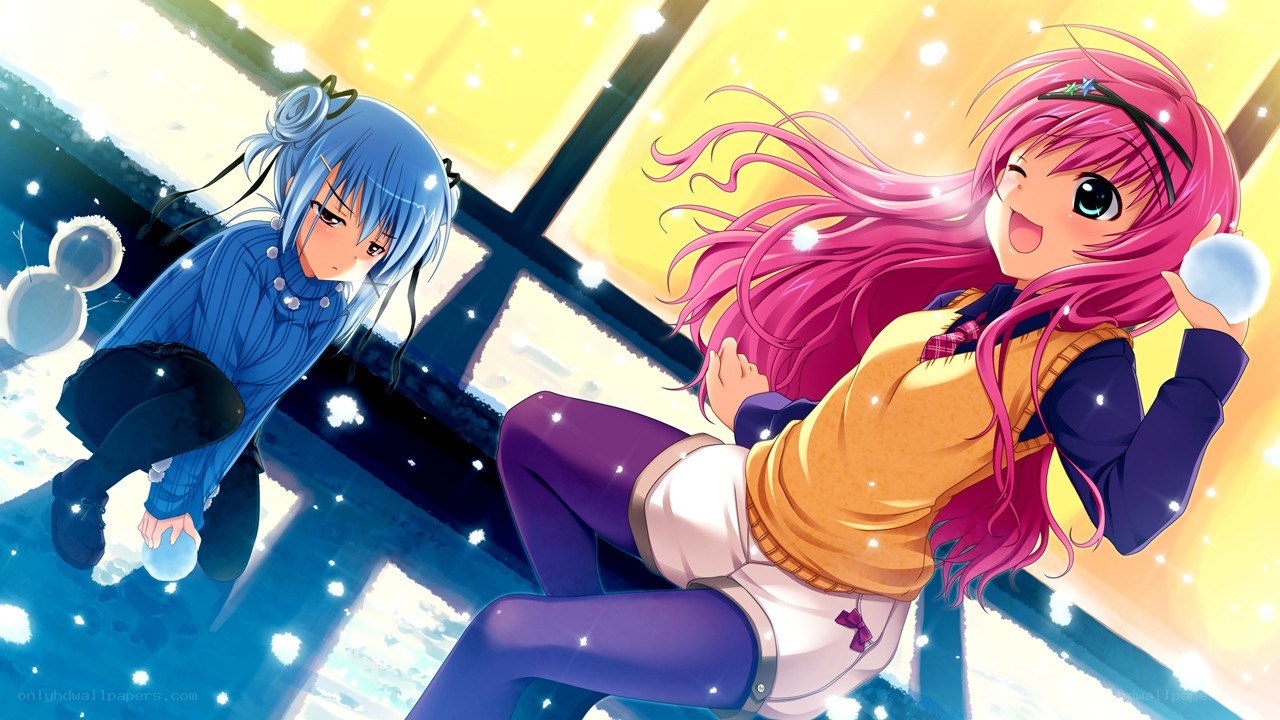 Two girls playing with snowballs