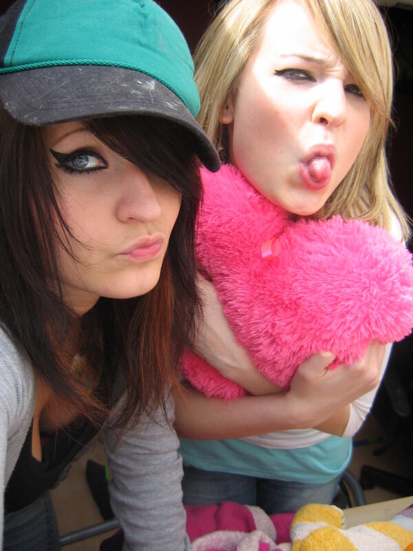 Two girls posing with a stuffed animal