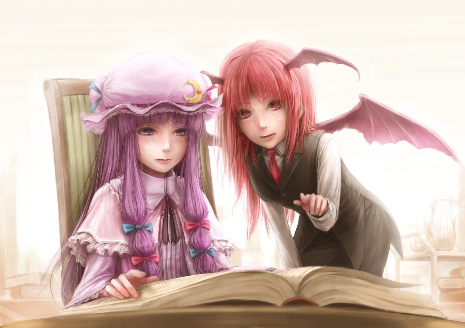 Two girls reading a book together