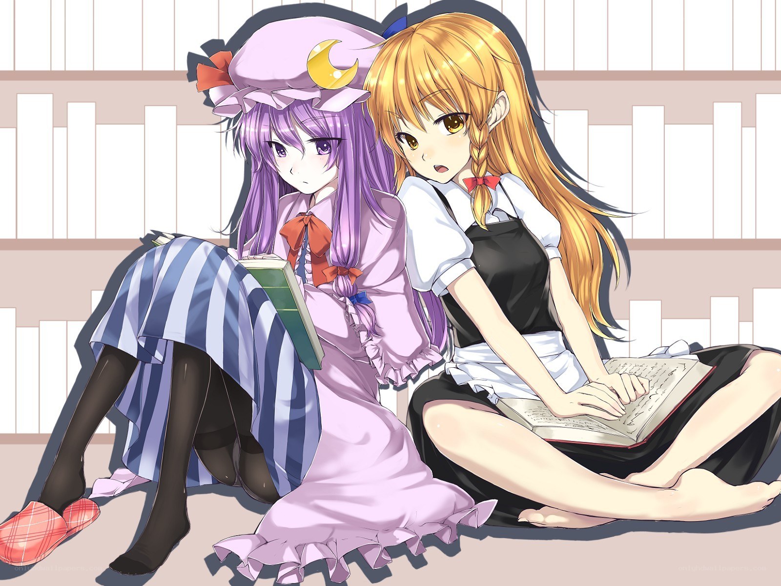 Two girls reading in a library
