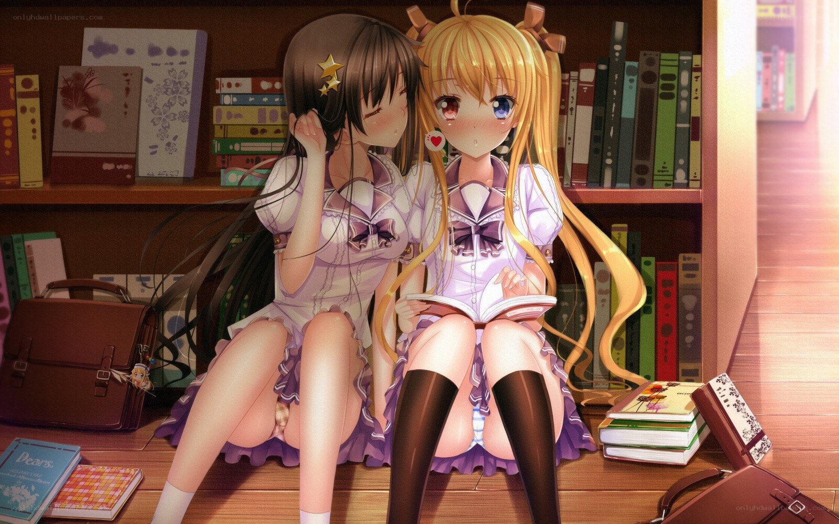 Two girls reading in a library