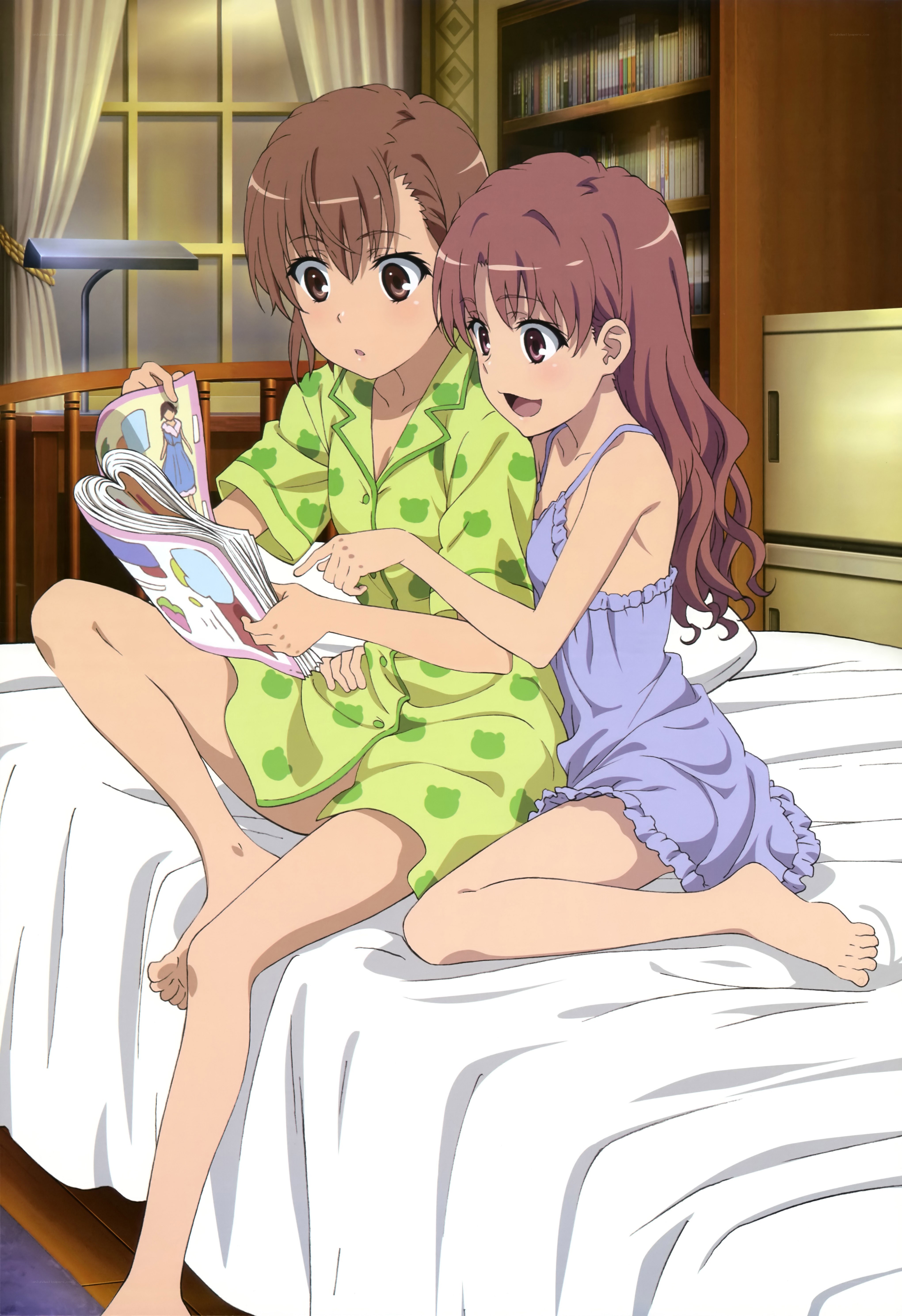 Two girls reading in bed