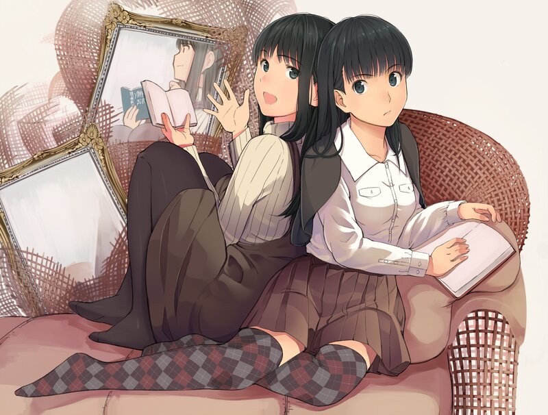 Two girls reading on a wicker chair