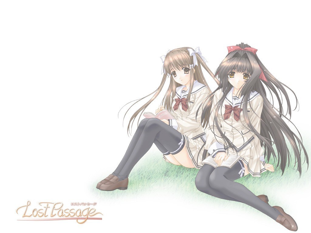 Two girls reading on grass