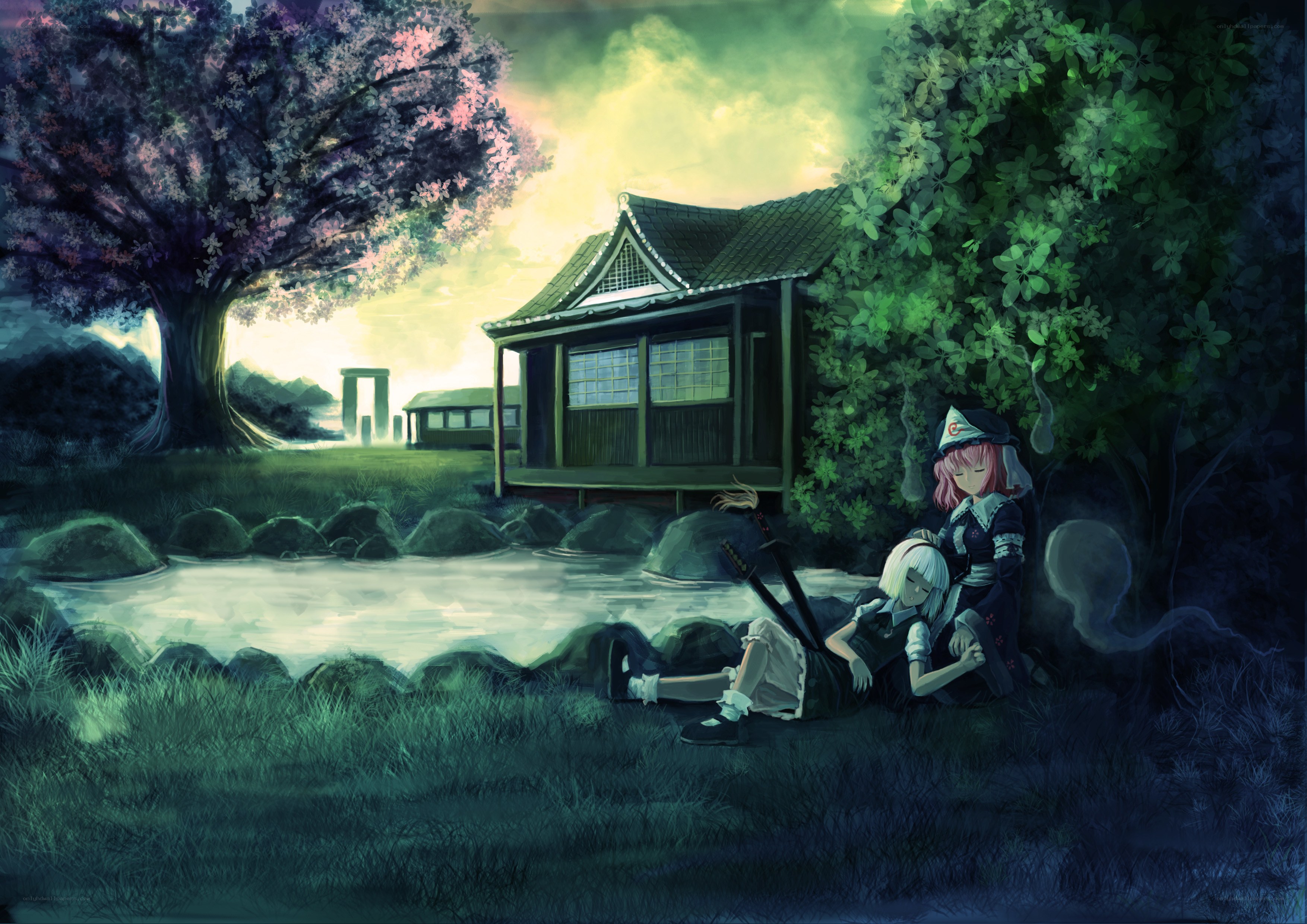 Two girls resting by a pond