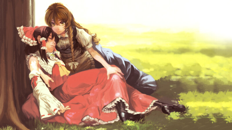 Two girls resting in a field