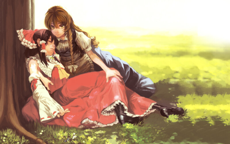 Two girls resting in a field