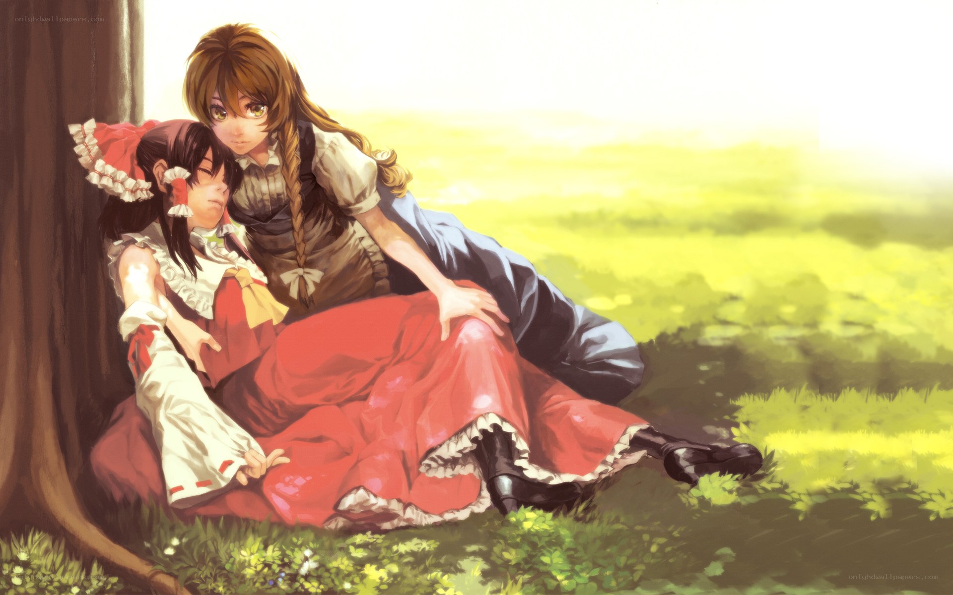 Two girls resting in a field