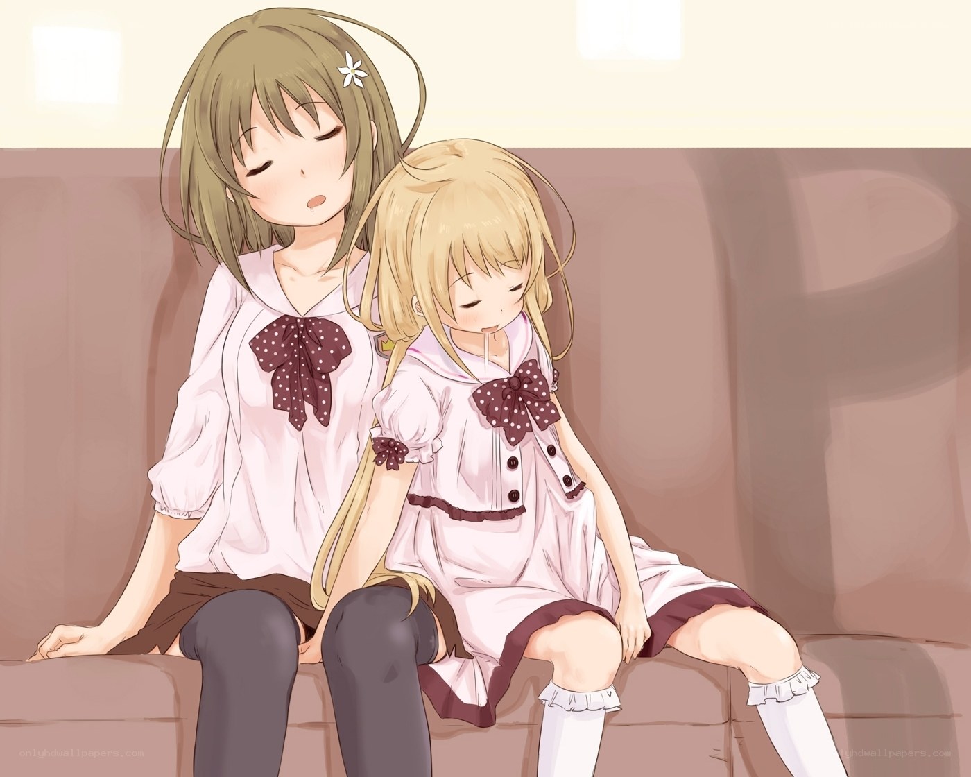 Two girls resting on a couch