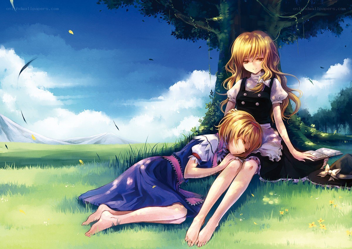 Two girls resting under a tree