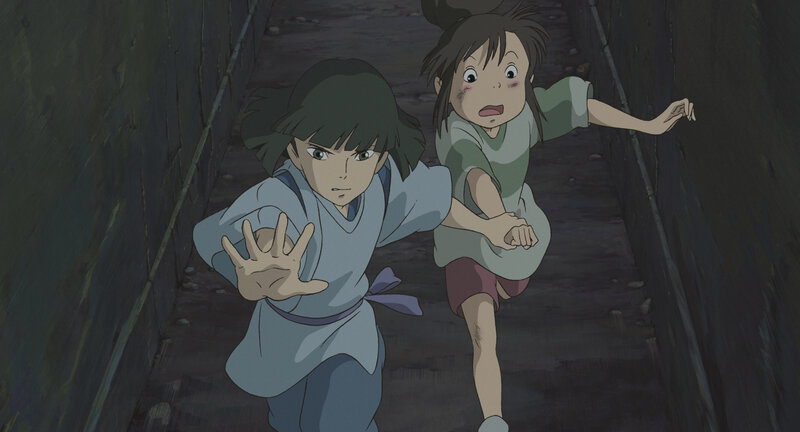 Two girls running in a tunnel
