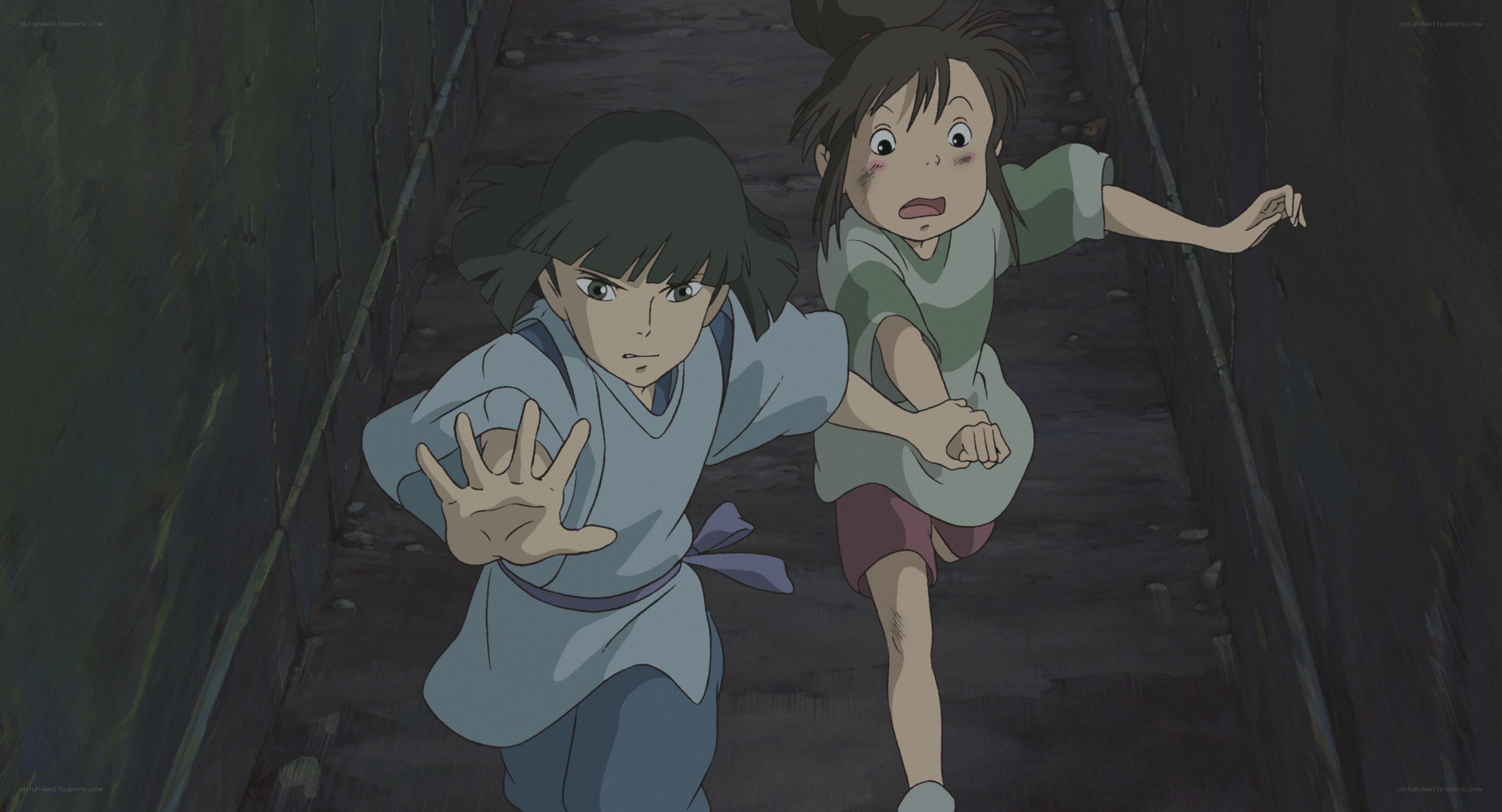 Two girls running in a tunnel