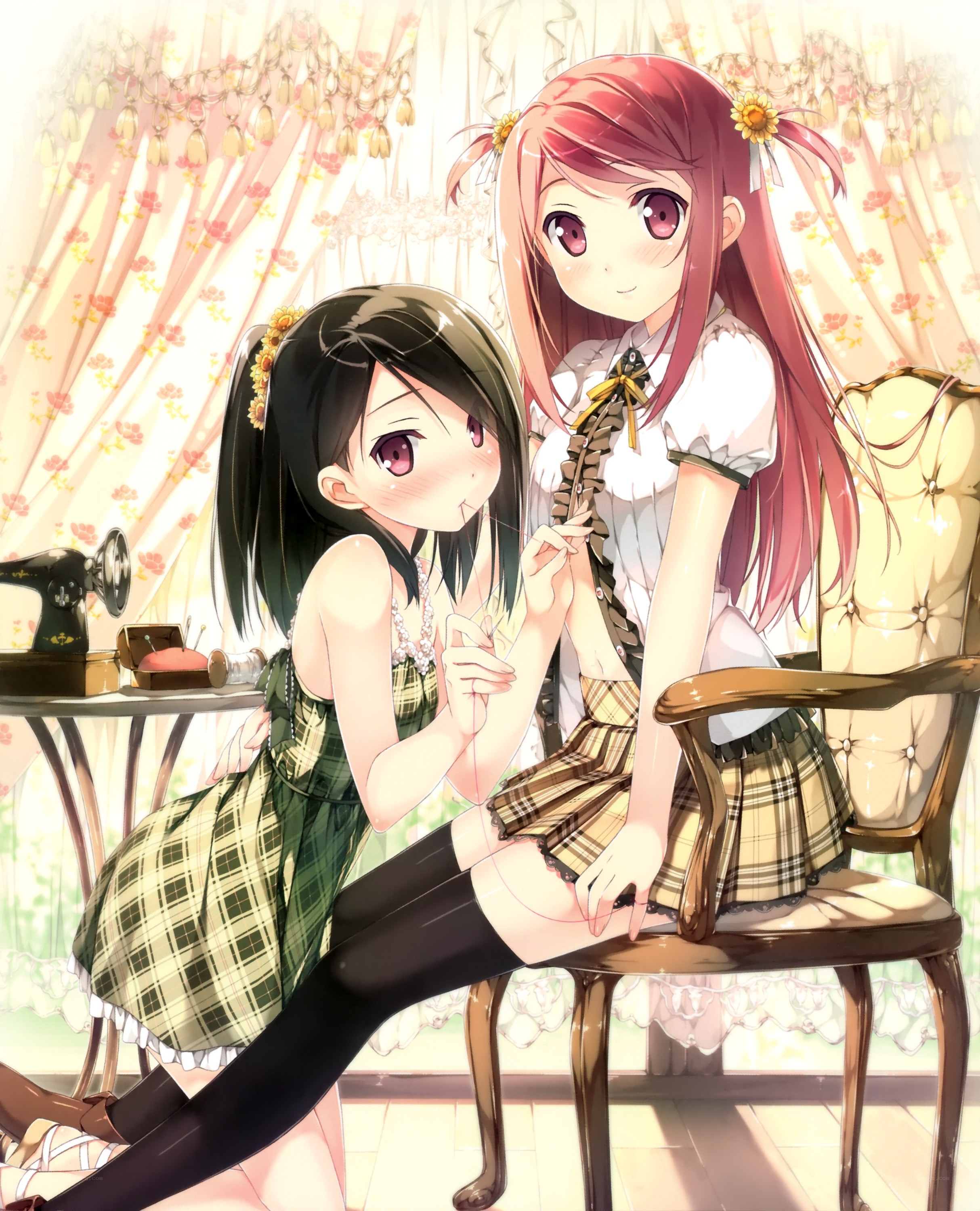 Two girls sewing together