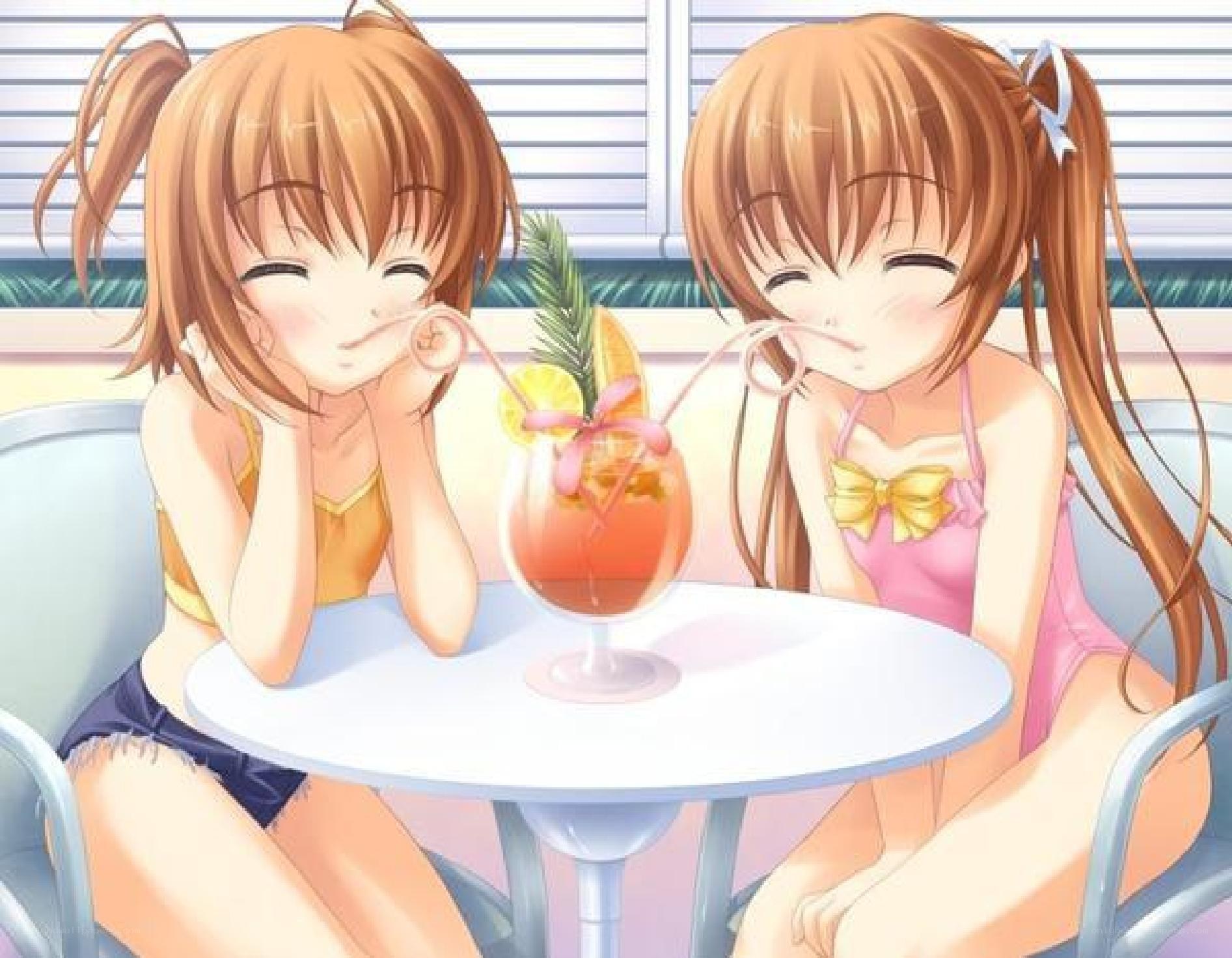 Two girls sharing a drink