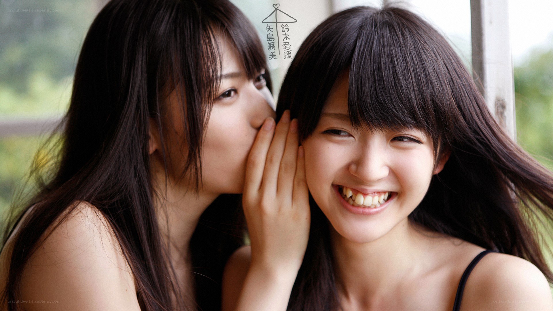 Two girls sharing a secret
