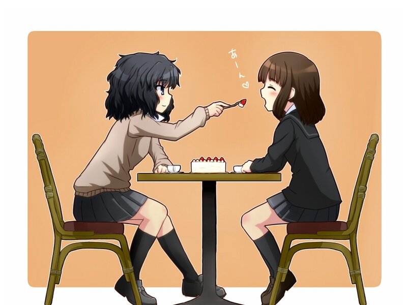Two girls sharing cake