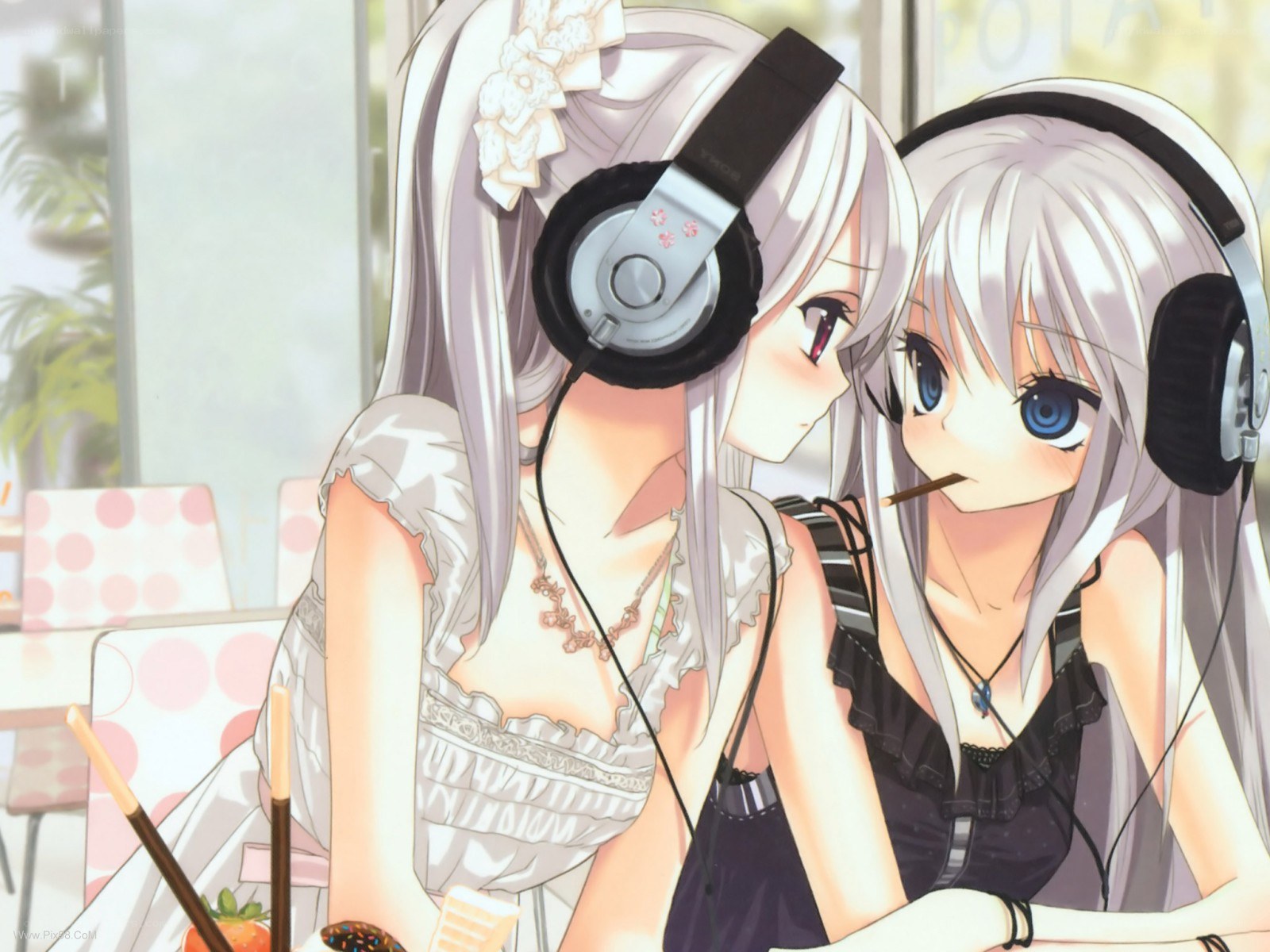 Two girls sharing headphones